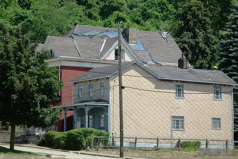 Two-storey house in McKeesport, Pennsylvania, clad in diamond-pattern asbestos-cement siding shingles.
