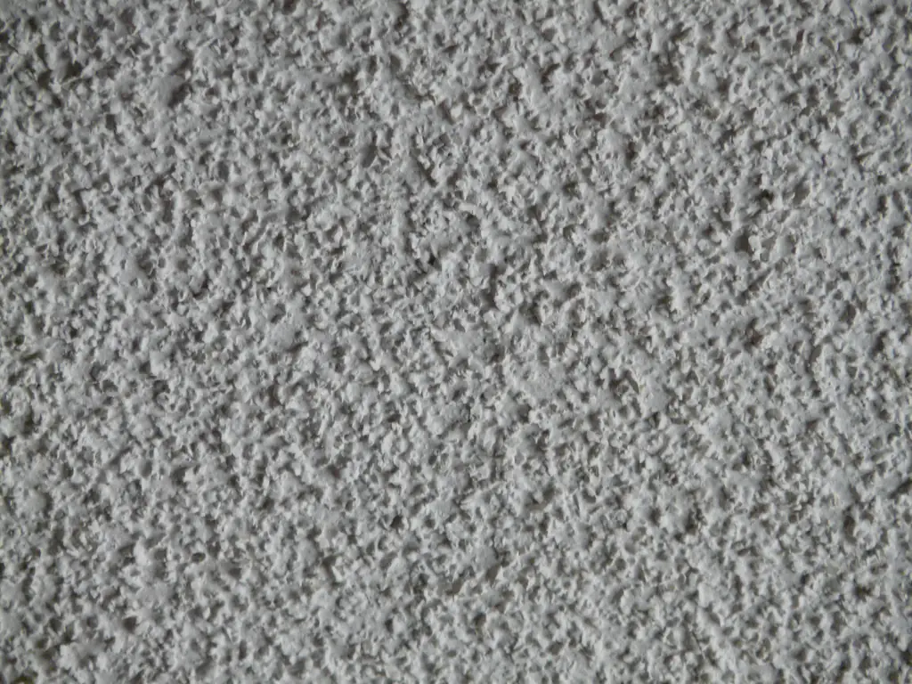 Close-up of a white popcorn ceiling texture with small lumps