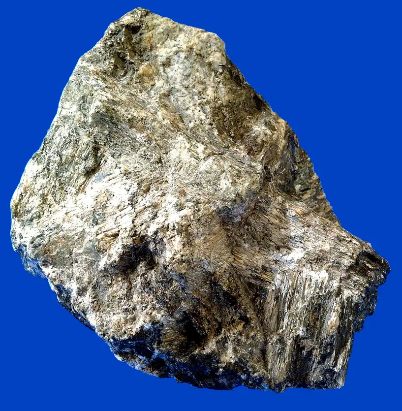 Hand specimen of chrysotile, a fibrous mineral, showing silky grey-green fibre bundles in rock