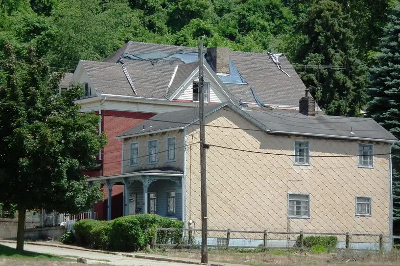 Two-storey house in McKeesport, Pennsylvania, clad in rectangular cement siding shingles